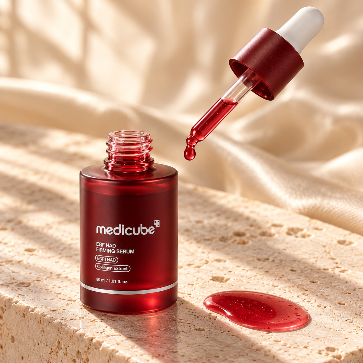 Medicube ruby red serum dropper on ivory stone