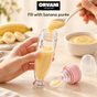 Filling the open baby feeder with banana purée