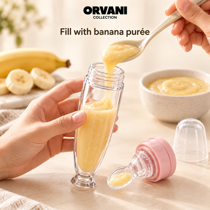 Filling baby spoon feeder with banana purée